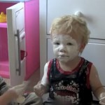 La hija mayor se queda cuidando del pequeño y le protege bien con crema solar