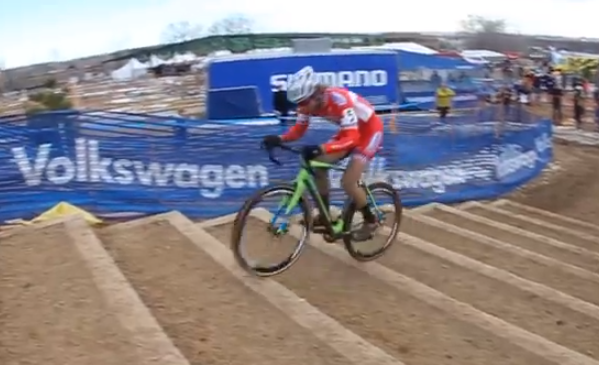 Un corredor sube las escaleras sin pedalear durante una carrera de ciclocross