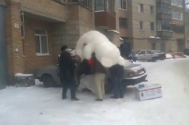 Metiendo un enorme oso de peluche en el coche... Rusia