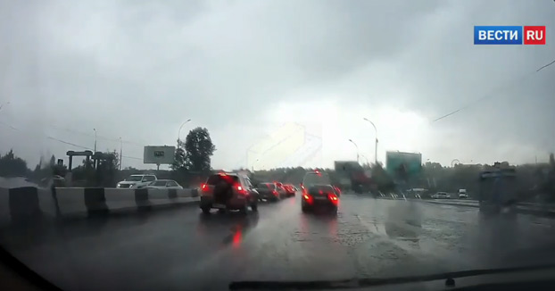 Un rayo cae sobre un coche mientras circula por una calle de la ciudad rusa de Novosibirsk